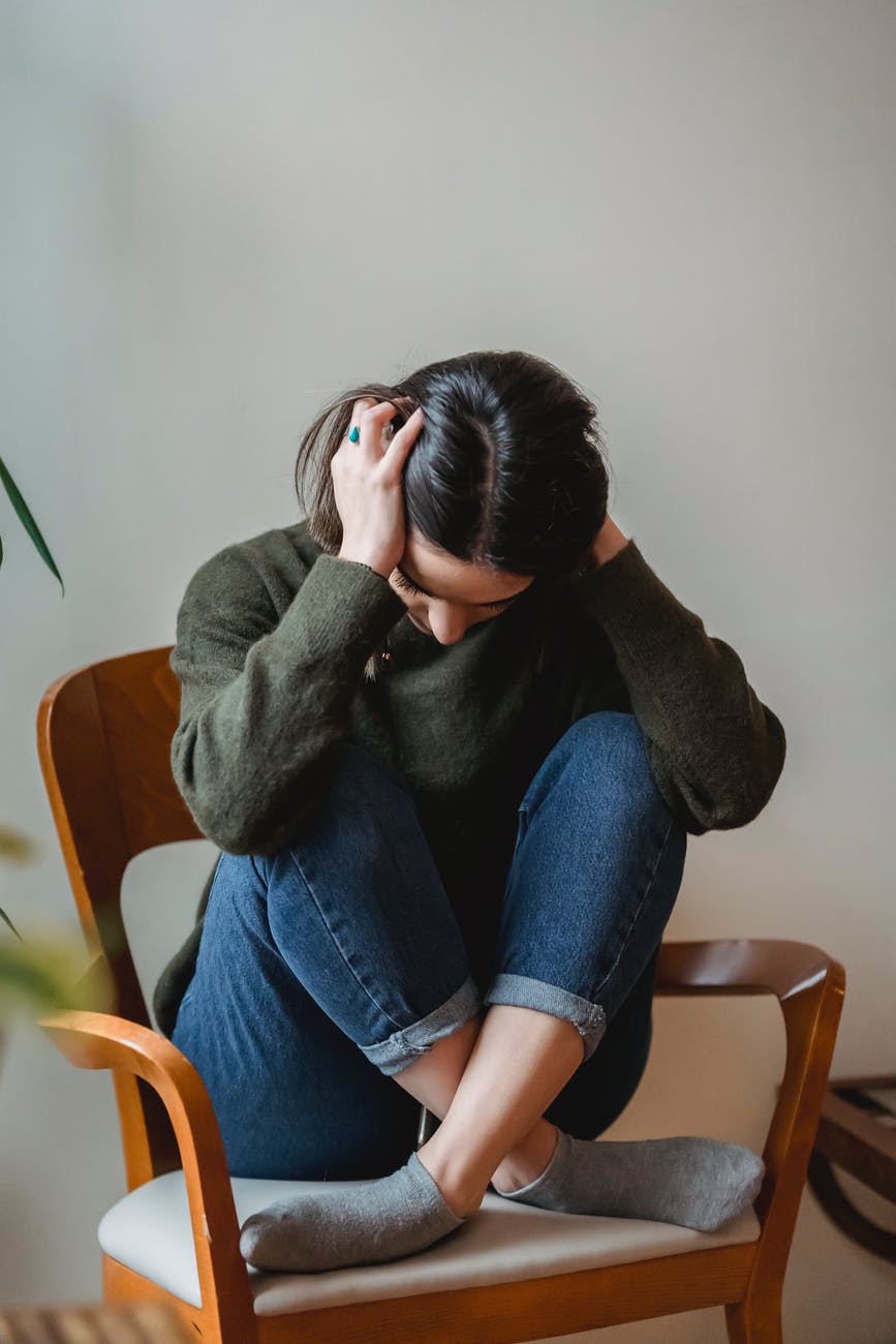 Photo by Liza Summer on <a href="https://www.pexels.com/photo/anxious-young-woman-cover-wing-ears-with-hands-sitting-on-chair-6382633/" rel="nofollow">Pexels.com</a>