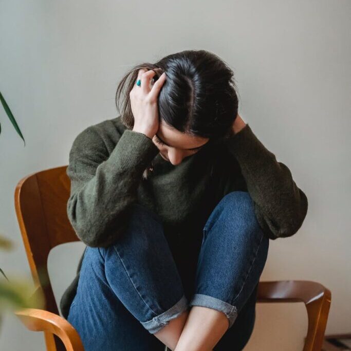 Photo by Liza Summer on <a href="https://www.pexels.com/photo/anxious-young-woman-cover-wing-ears-with-hands-sitting-on-chair-6382633/" rel="nofollow">Pexels.com</a>